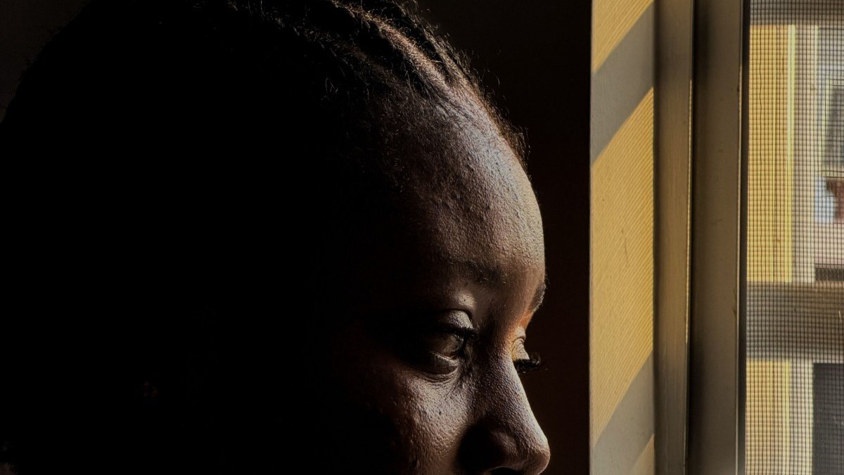 A supportive therapy session with a Black woman and therapist.