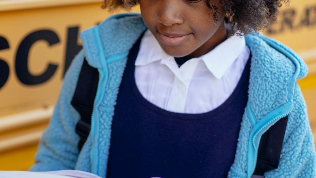 Black girl reading outdoors