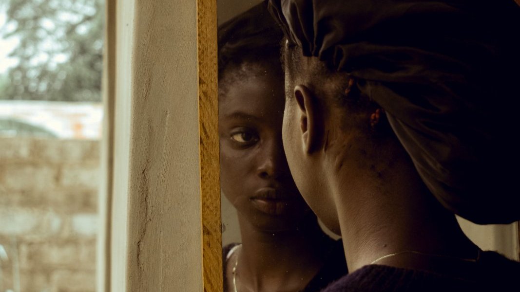 Black woman resting during a quiet moment at home.