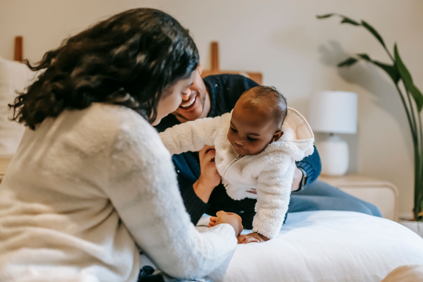 A supportive partner helping a new mother.