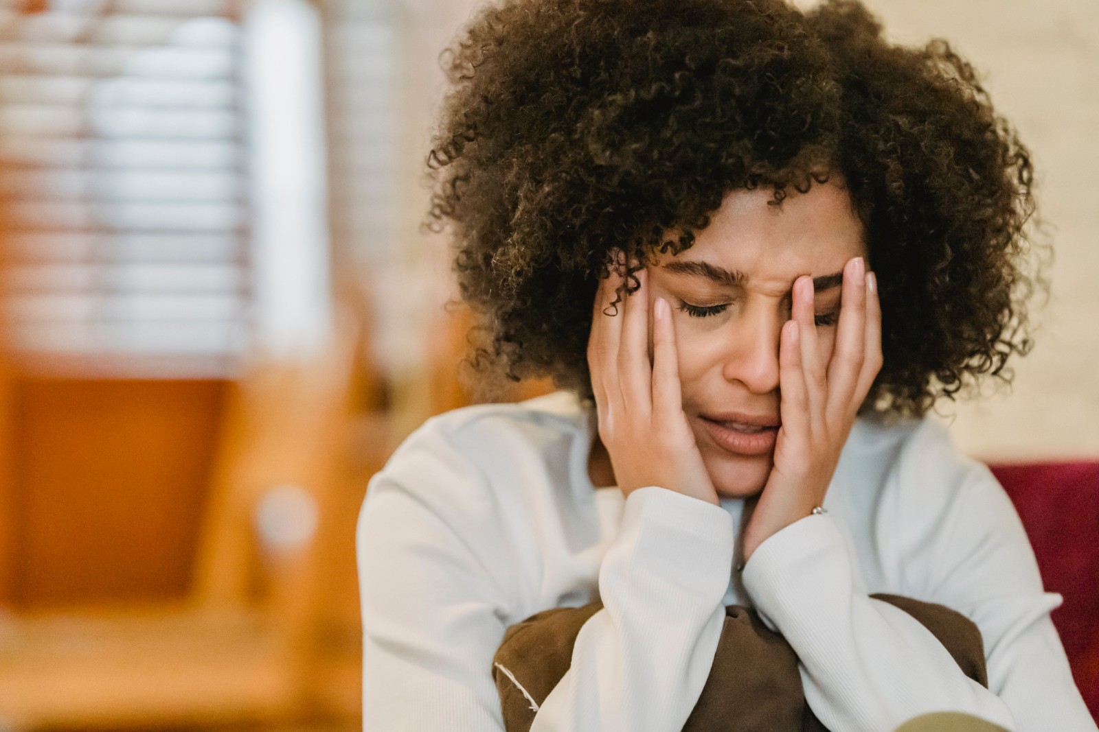 A woman experiencing a panic attack, looking distressed.