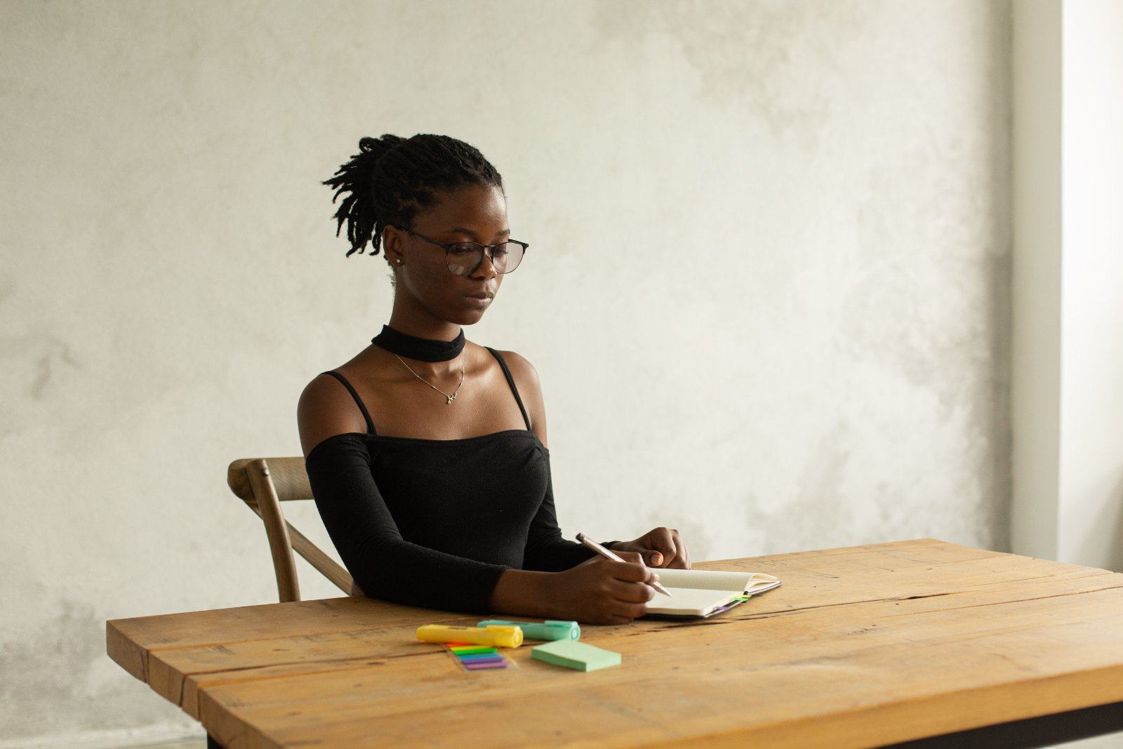 Black couple sitting on a sofa and having a thoughtful conversation at home.