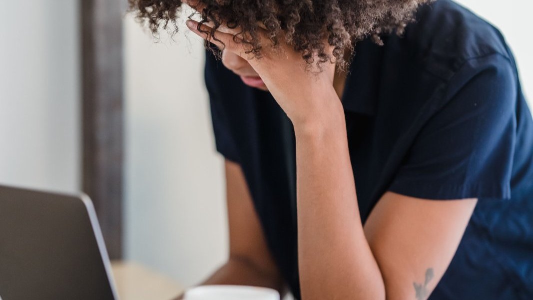 A woman looking thoughtfully at her to-do list