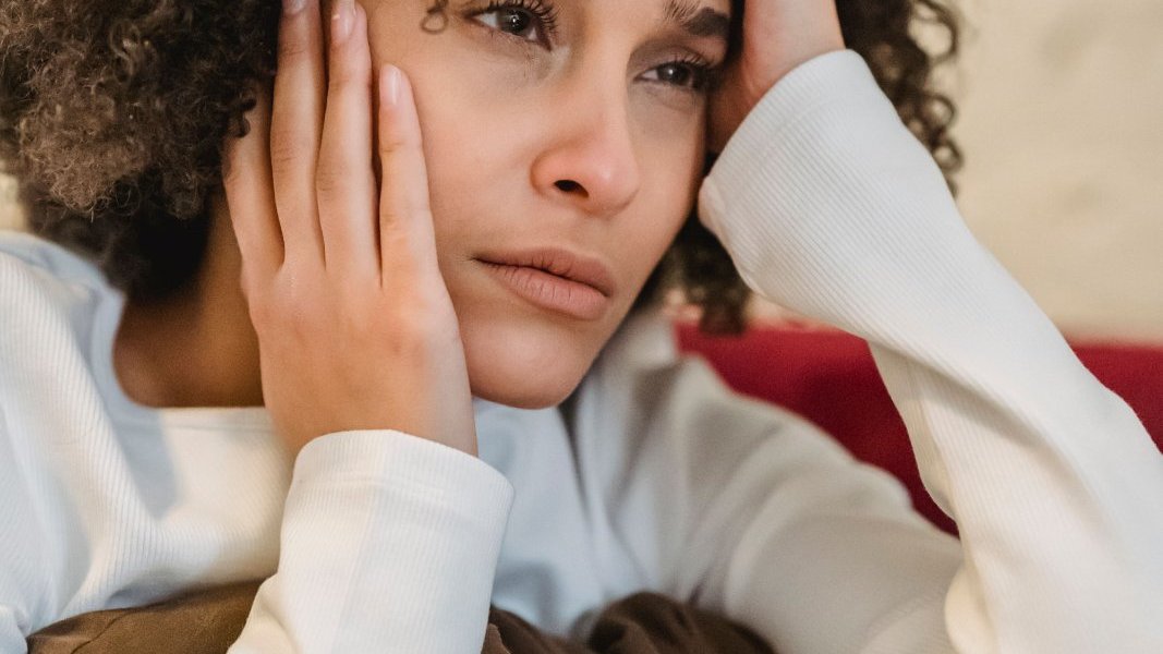 A Black woman reflecting on her emotional needs.