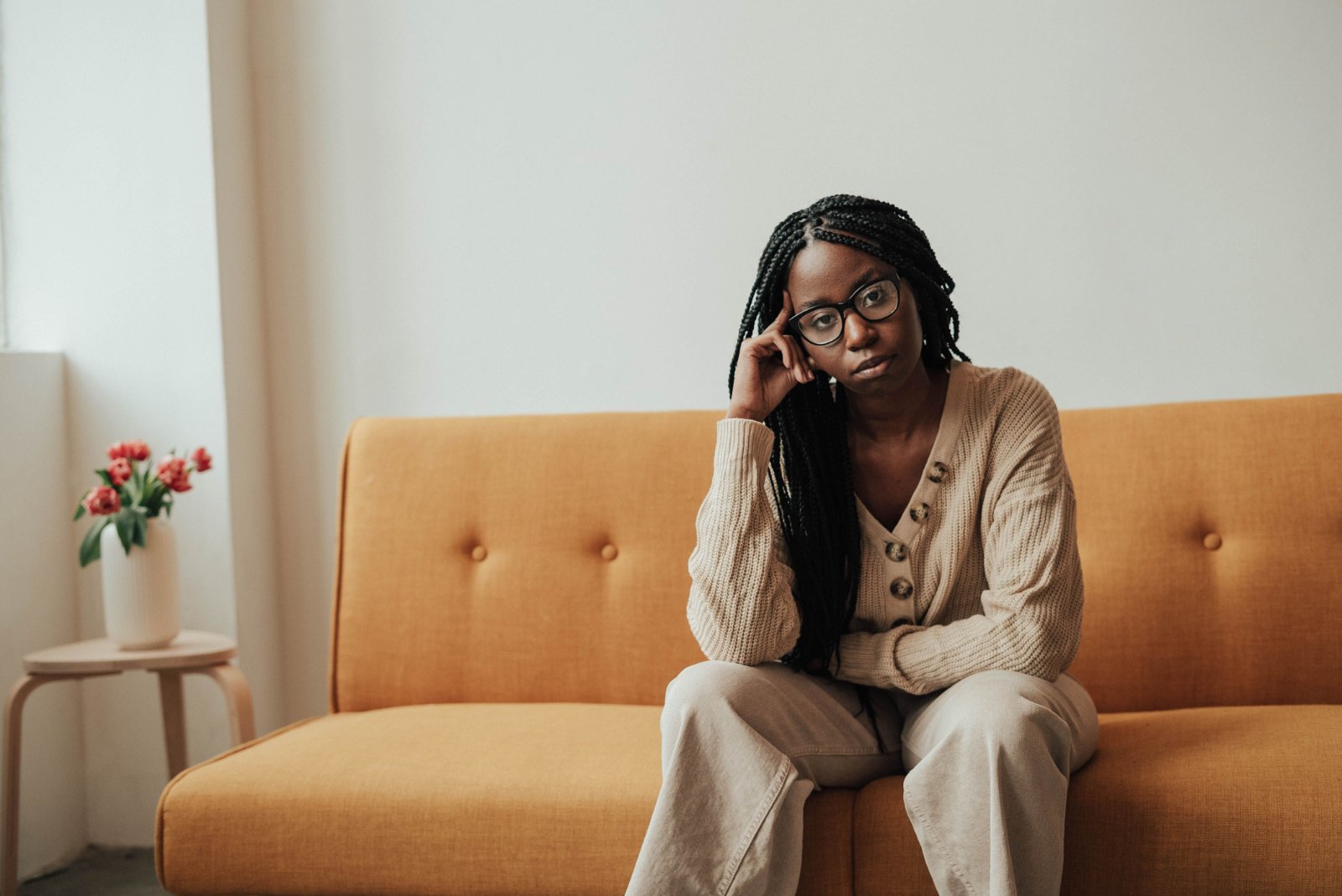 A woman looking thoughtfully at her laptop.