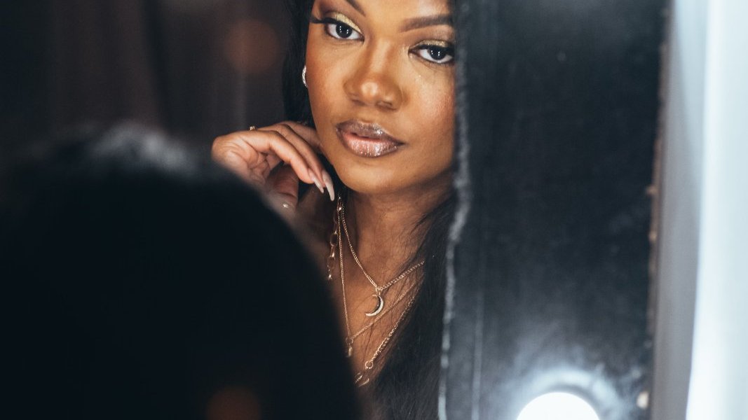 A woman reflecting on her feelings in a serene environment.