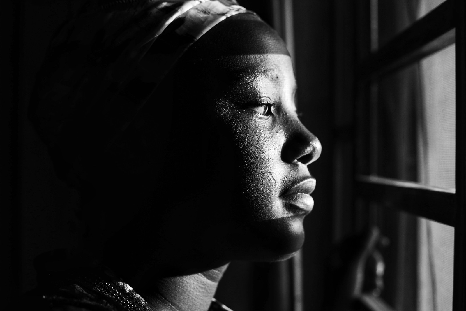 A Black woman looking contemplative, reflecting on her mental health.
