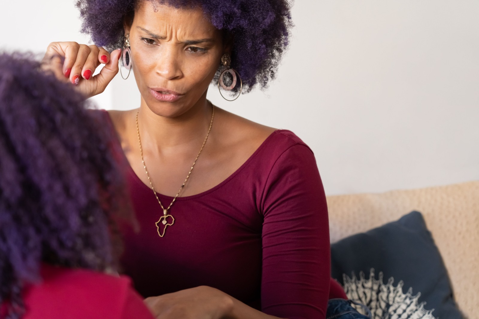 A Black woman reflecting thoughtfully in a serene environment.