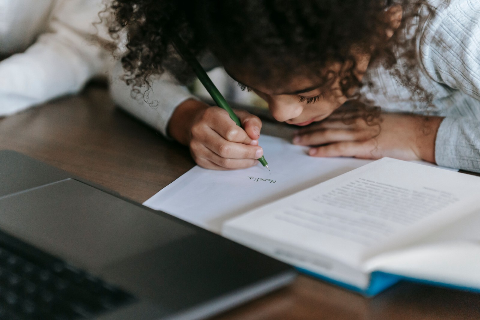 A group of diverse Black girls engaged in a reading activity.