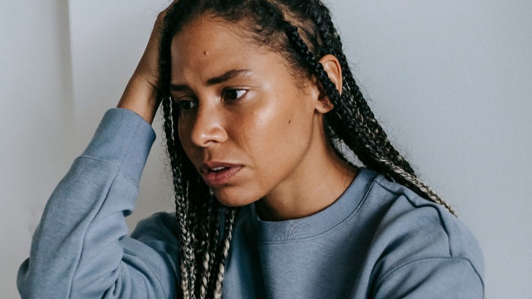 A Black woman reflecting on her feelings