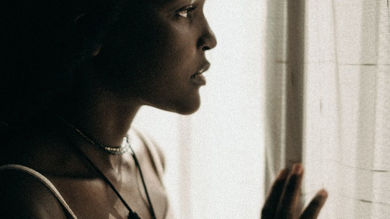 A thoughtful Black woman reflecting on her childhood
