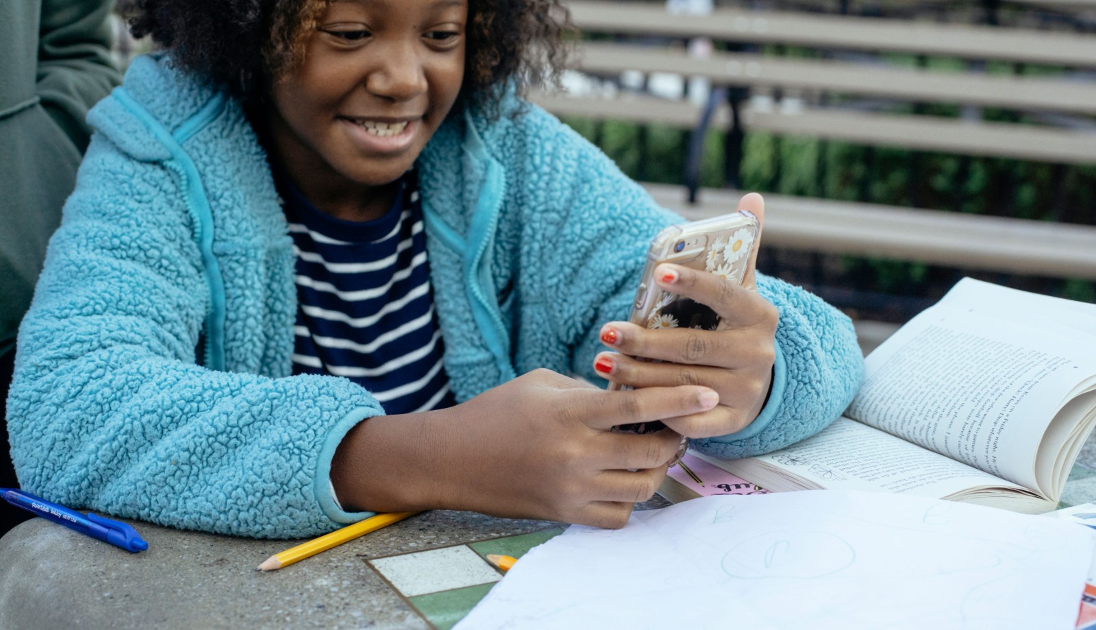 Black girl sitting at a desk looking overwhelmed with schoolwork.