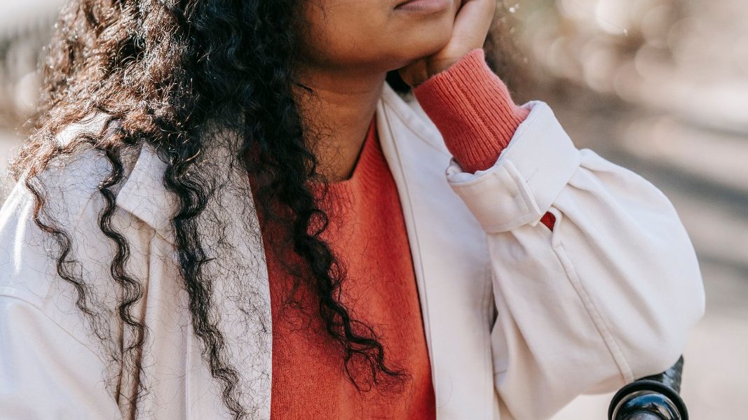 A Black woman practicing mindfulness in a serene environment.