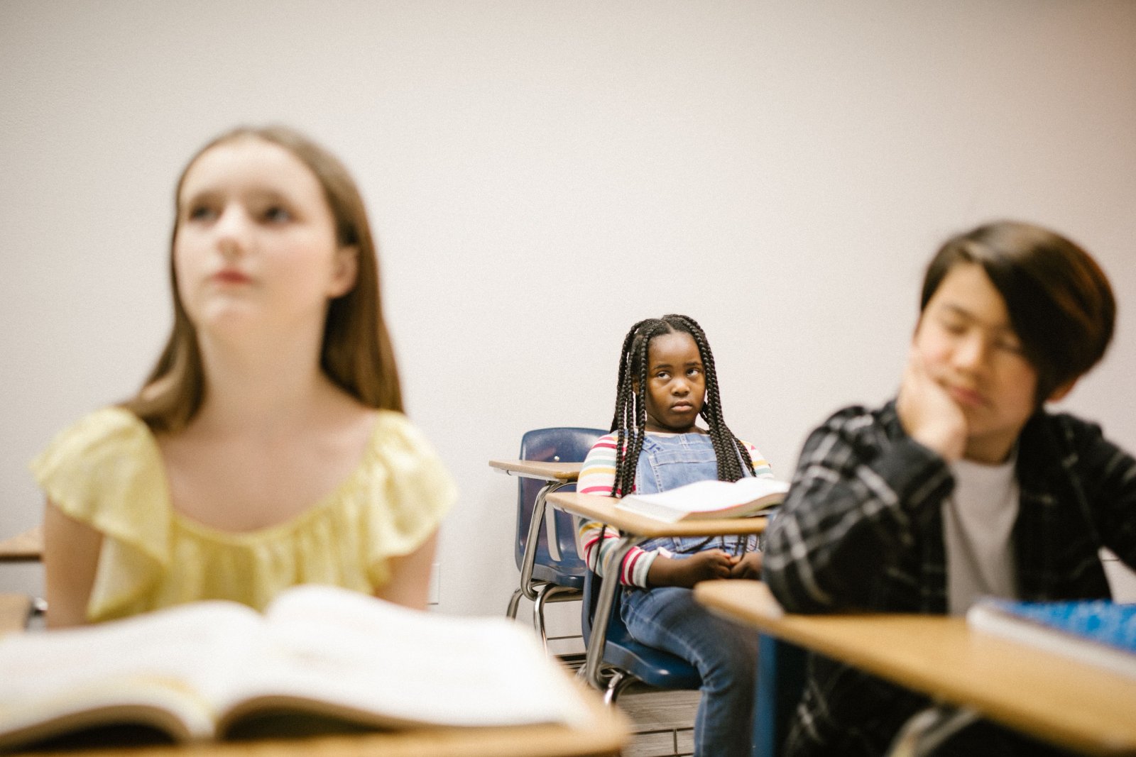 A young Black girl looking thoughtful and engaged.