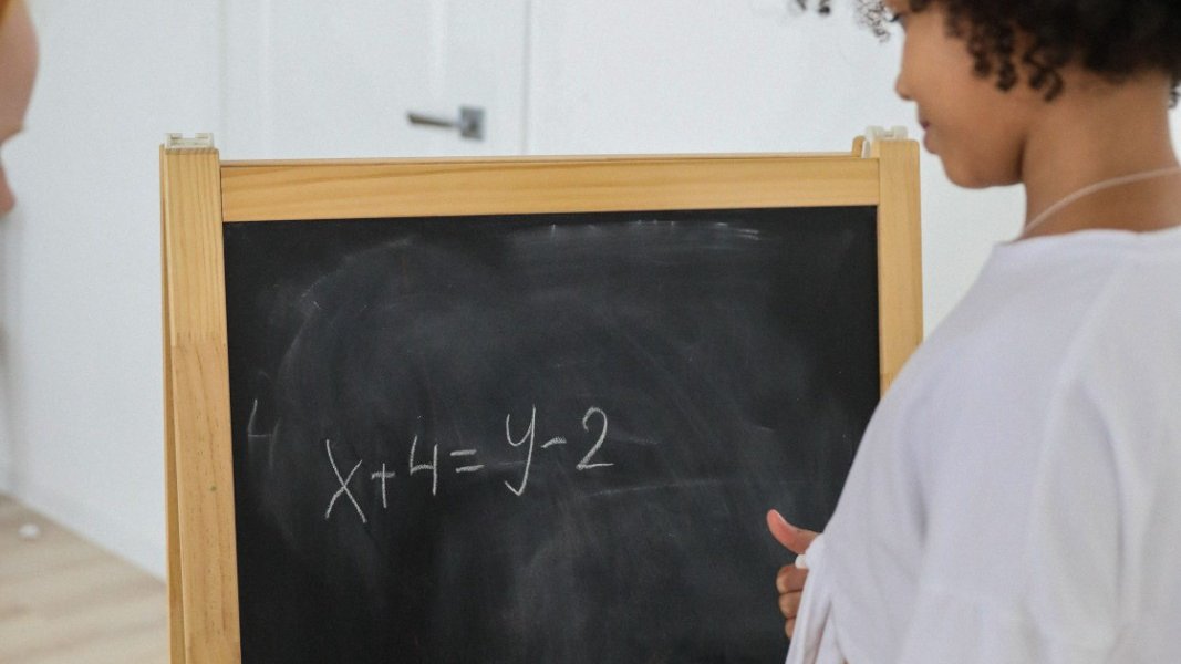 Black girl in classroom looking thoughtful