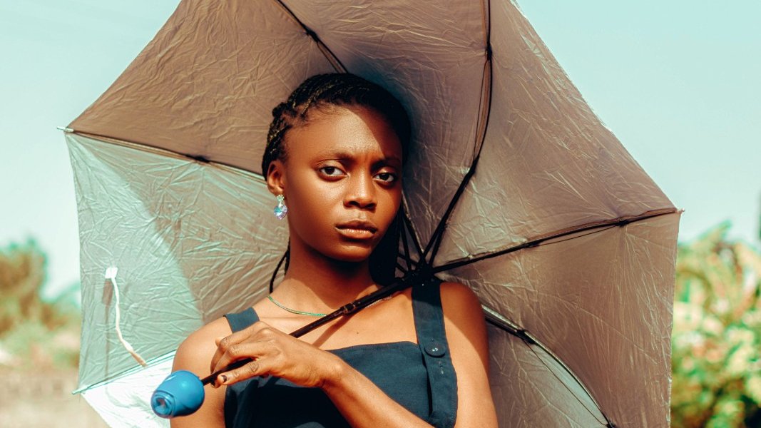 A young Black girl looking contemplative.