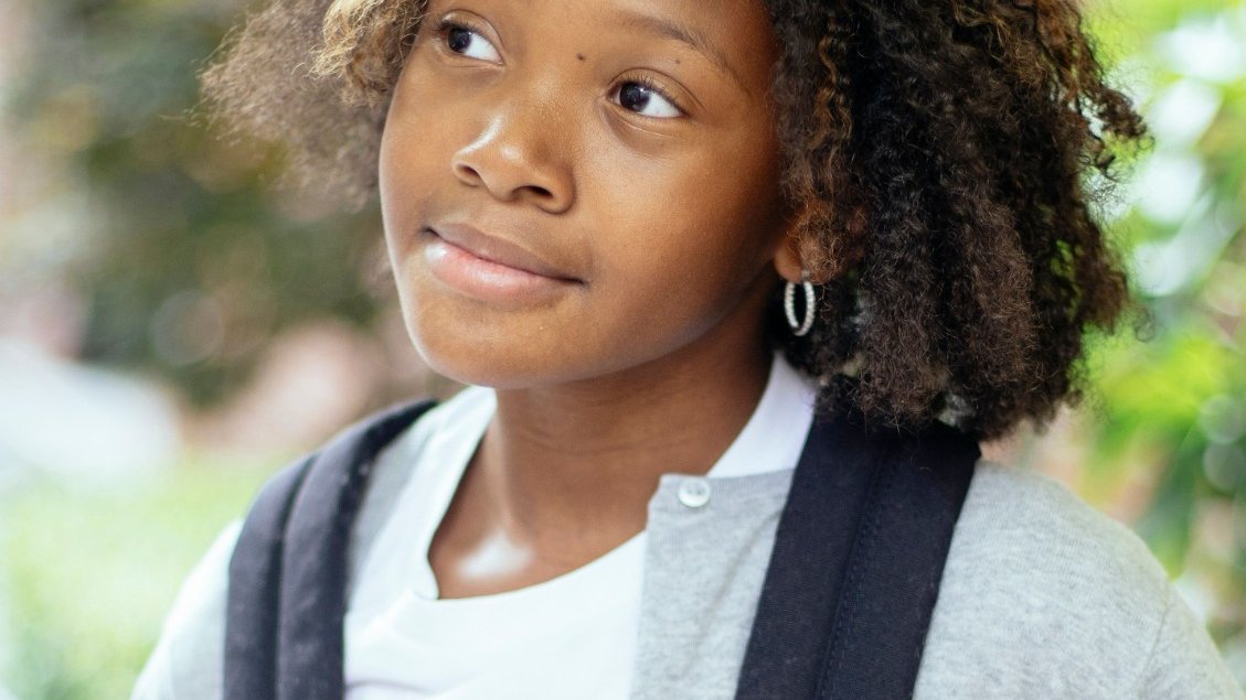A Black girl looking anxious about school